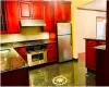 Kitchen with appliances with stainless steel finishes, backsplash, sink, pendant lighting, and dark stone countertops