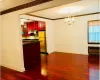 Kitchen featuring decorative light fixtures, stainless steel fridge, dark hardwood / wood-style flooring, and radiator heating unit