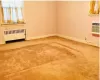 Empty room with radiator heating unit and a wall mounted air conditioner