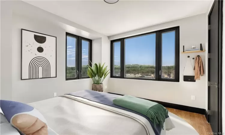 Bedroom with light hardwood / wood-style flooring