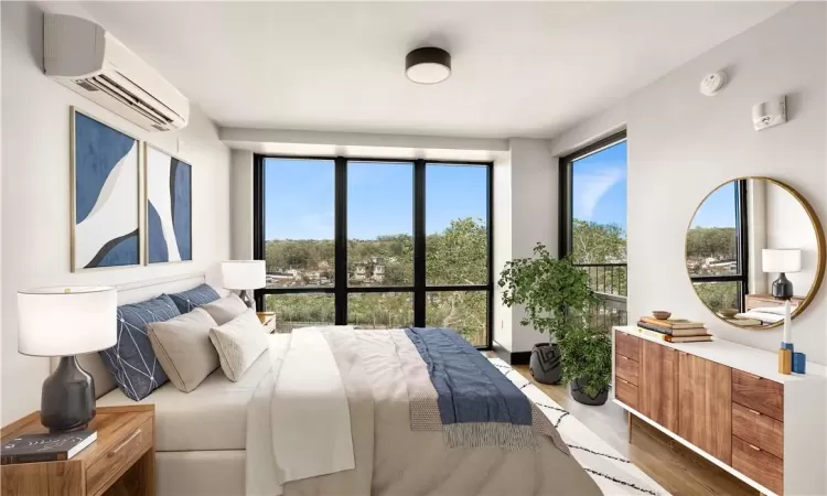 Bedroom with wood-type flooring and an AC wall unit