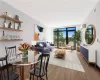 Dining room with floor to ceiling windows, hardwood / wood-style floors, and a wall mounted AC