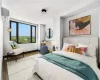 Bedroom featuring a wall mounted AC and light hardwood / wood-style flooring