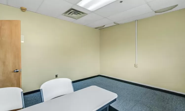 Carpeted home office with a drop ceiling