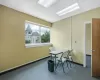 Carpeted office with a paneled ceiling