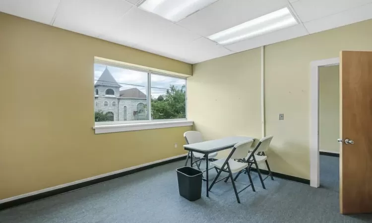 Carpeted office with a paneled ceiling