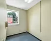 Empty room with a drop ceiling and carpet floors