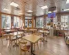 Dining area with wood walls, a healthy amount of sunlight, and hardwood / wood-style flooring