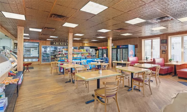 Dining room featuring hardwood / wood-style floors and wood walls