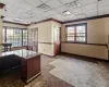 Home office with crown molding and a drop ceiling