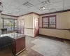 Unfurnished office with a drop ceiling and crown molding