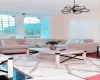 Living room with hardwood / wood-style floors, a notable chandelier, and breakfast area