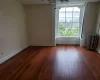 Unfurnished room with radiator heating unit and dark hardwood / wood-style floors