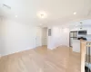 Unfurnished living room with light wood-type flooring and electric panel