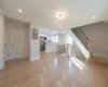 Unfurnished living room with light hardwood / wood-style floors, sink, and electric panel