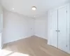 Unfurnished bedroom with a closet and light hardwood / wood-style flooring