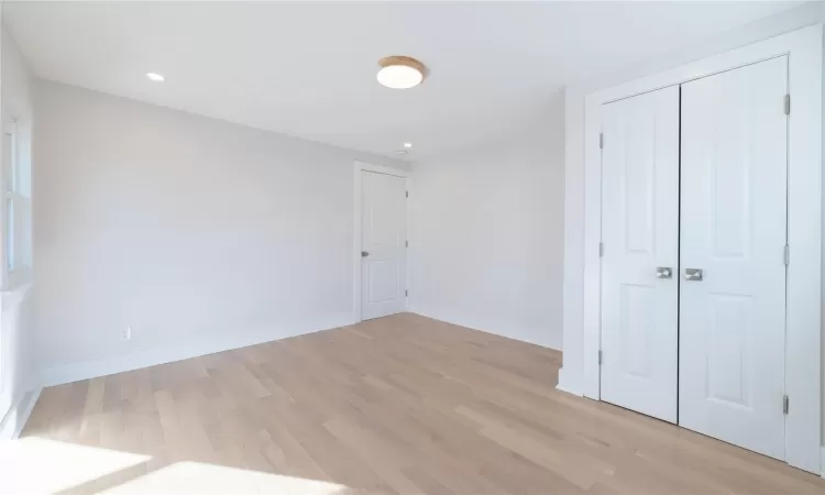 Unfurnished bedroom with a closet and light hardwood / wood-style flooring