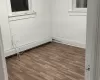 Spare room with a baseboard radiator and hardwood / wood-style flooring