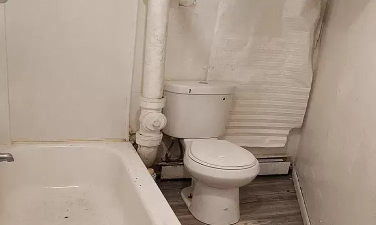 Bathroom with hardwood / wood-style floors and toilet