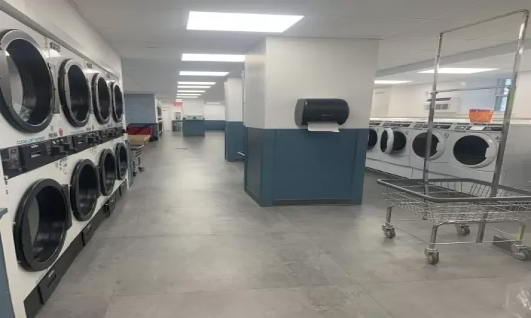 Laundry area featuring stacked washing maching and dryer and separate washer and dryer