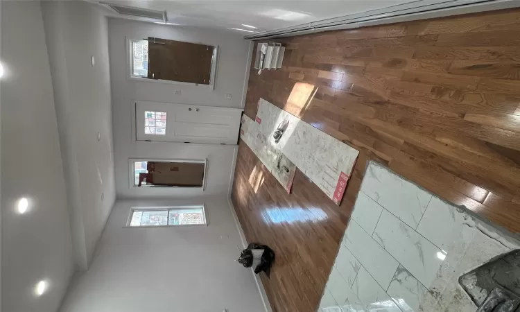 Entrance foyer featuring dark hardwood / wood-style floors and a baseboard radiator