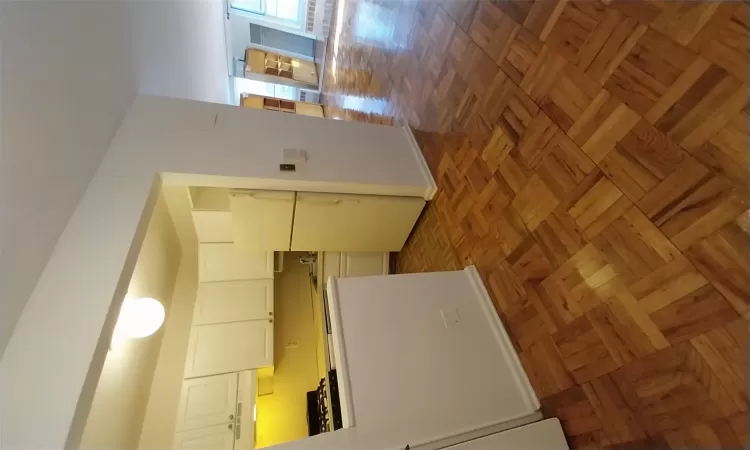 Hallway featuring tile patterned flooring and baseboards