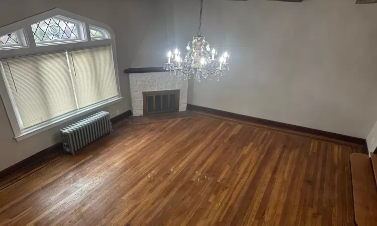 Unfurnished bedroom featuring dark wood-type flooring