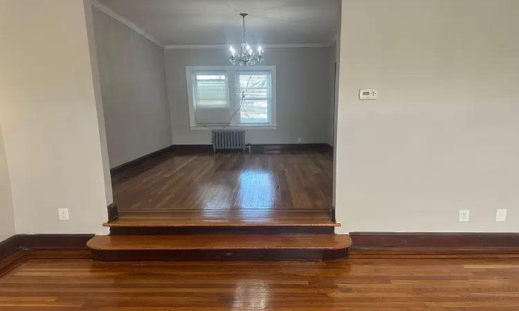 Bathroom with radiator heating unit, vanity, plenty of natural light, and toilet