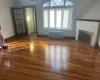 Unfurnished living room featuring a fireplace, ornamental molding, dark hardwood / wood-style floors, and a notable chandelier