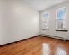 Spare room with hardwood / wood-style floors and baseboard heating