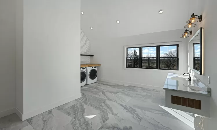 Laundry room located in full bathroom off the second floor hallway