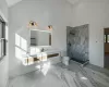 Bathroom featuring vanity, toilet, a shower, and a towering ceiling. Hallway bathroom.