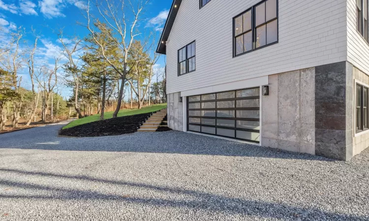 View of property exterior featuring a garage