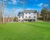 Rear view of property featuring a yard