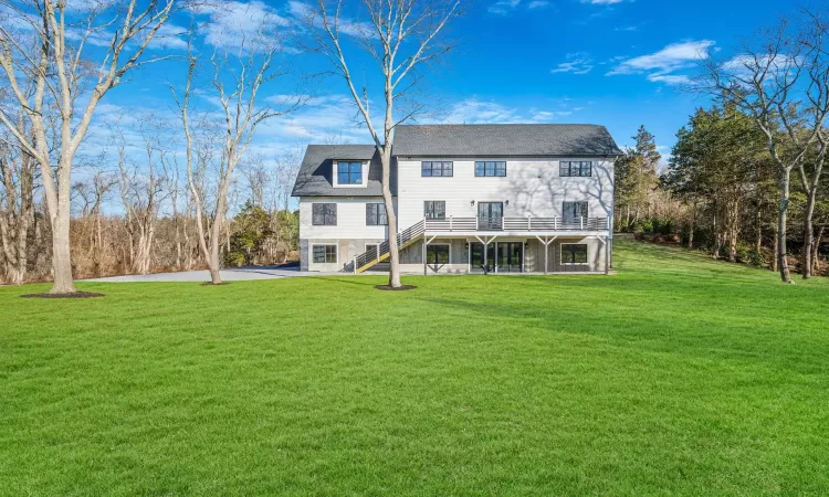 Rear view of property featuring a yard