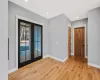 Doorway with french doors and direction to half bathroom and primary bedroom