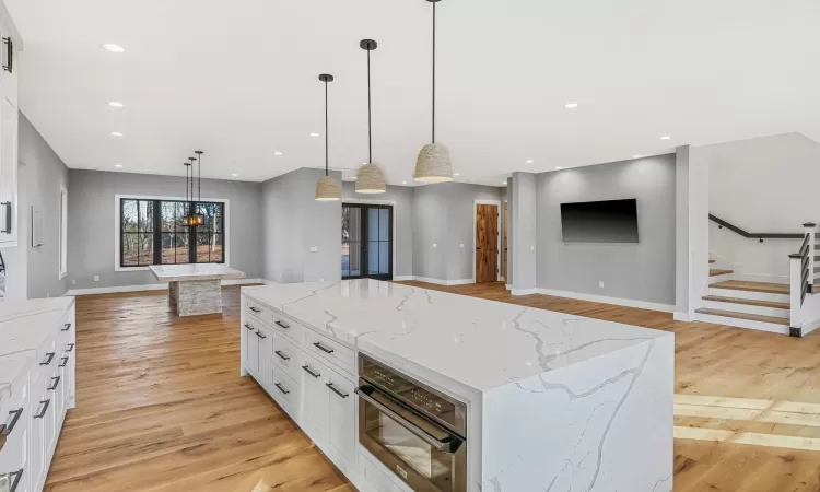 Kitchen featuring white cabinets, a spacious island