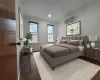 Bedroom with a wall mounted AC and dark hardwood / wood-style floors