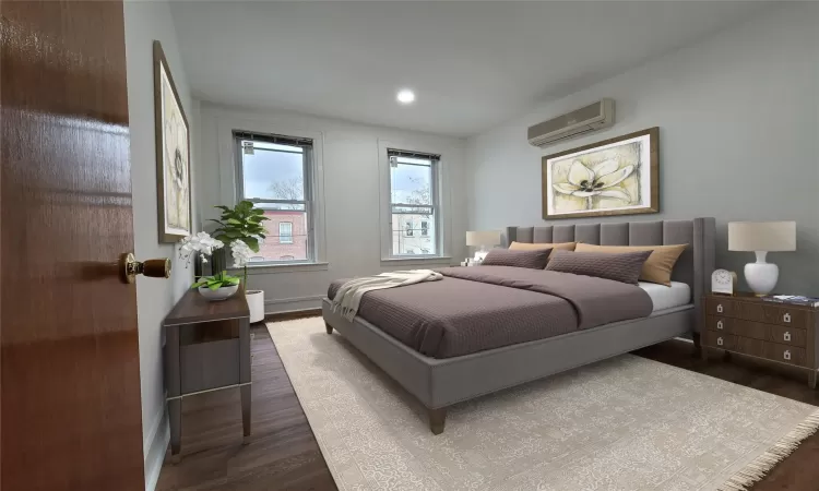 Bedroom with a wall mounted AC and dark hardwood / wood-style floors