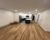 Kitchen featuring white cabinets, a center island, stainless steel appliances, and light hardwood / wood-style flooring