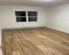 Spare room featuring baseboard heating and light hardwood / wood-style flooring