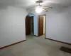 Unfurnished room featuring ceiling fan and light colored carpet