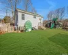 Rear view of house featuring a playground and a yard