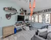 Office area with baseboard heating, light hardwood / wood-style floors, and lofted ceiling