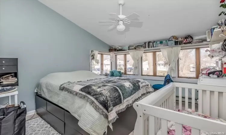 Bedroom with ceiling fan and lofted ceiling