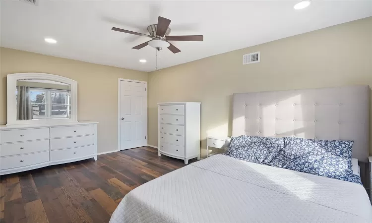 Bedroom with ceiling fan and dark hardwood / wood-style flooring