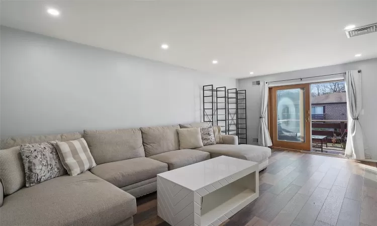 Living room with dark hardwood / wood-style flooring