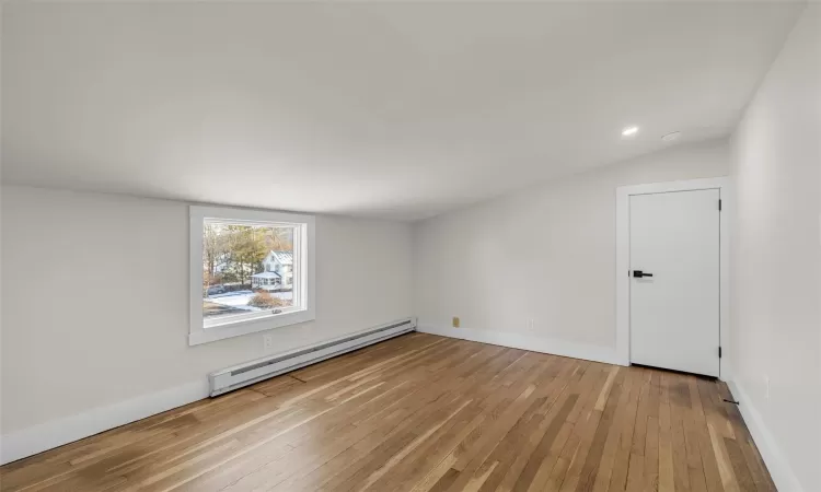 Bedroom 3 on second level with light hardwood /  and baseboard heating