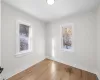 Bedroom 1 featuring light hardwood floors.  Unfurnished.