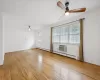 Empty room with baseboard heating, ceiling fan, and light hardwood / wood-style flooring